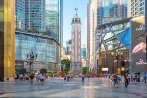 a group of people walking in a city with tall buildings at Fanbo Jingcheng Hotel (Hongyadong Branch, Jiefangbei Pedestrian Street, Chongqing) in Nan'an