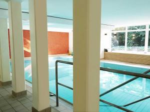 a view of a swimming pool in a building at Hotel Ancora Timmendorfer Strand, Pool inklusive in Timmendorfer Strand