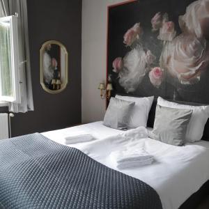 a bedroom with a bed with a painting on the wall at Villa Burgau, C&H in Monschau