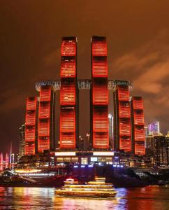 a group of tall skyscrapers in a city at night at 云深处江景公寓 in Chongqing