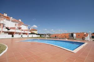 a swimming pool in front of a building at Granny's House by Trip2Portugal in Carvoeira