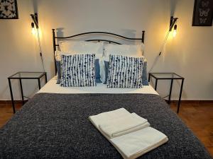 a bed with two nightstands and two towels on it at Granny's House by Trip2Portugal in Carvoeira +31 photos