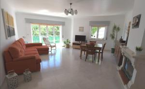 a living room with a couch and a table at Granny's House by Trip2Portugal in Carvoeira