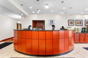 an office lobby with an orange and red counter at Quality Inn Near Interstate I94 in New Buffalo +38 photos
