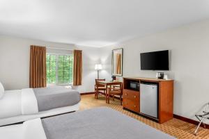 a hotel room with two beds and a flat screen tv at Quality Inn Near Interstate I94 in New Buffalo