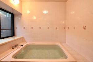 a bath tub in a bathroom with a window at Azumino salon2 in Azumino +39 photos