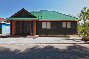 a brown house with a green roof at Azumino salon2 in Azumino