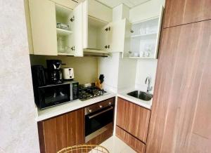 a small kitchen with a stove and a sink at Chic City Retreat Reva Residences Business Bay in Dubai