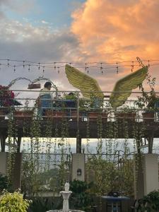 a man sitting on a pergola in a garden at Paradise Hills in Bungmati