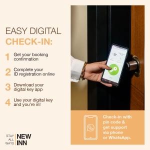 a person holding a cell phone in front of a door at Benesta Residence by NewInn in Istanbul
