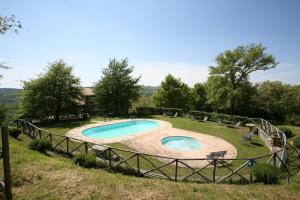 a pool in a field with a fence around it at Agriturismo La Cerqua in Molino Moscano