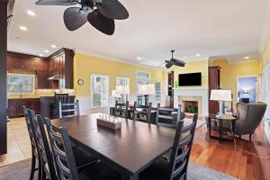 a dining room and living room with a table and chairs at AB15: 15 Atlantic Beach in Kiawah Island