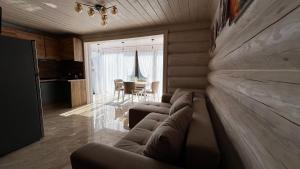 a living room with a couch and a dining room at Садиба Кичера Еко in Mizhhirʼʼya