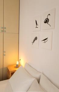 a bedroom with a bed and pictures on the wall at Down Town Sitia i in Sitia