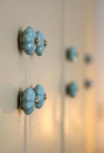 a bunch of blue door knobs on a wall at Down Town Sitia i in Sitia