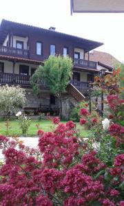 a house with pink flowers in front of it at Chorbadji Petkovi Hanove in Obzor