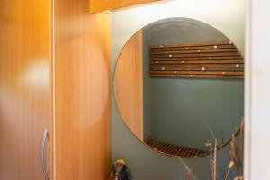 a mirror on a wall in a room at Holiday Home With Sunset Views Near Hvidbjerg in Hvidbjerg +27 photos