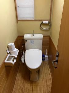 a small bathroom with a toilet and a window at ZEN Hostel in Yamanouchi +47 photos