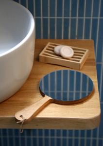 a wooden cutting board with a bowl and a measuring spoon at Down Town Sitia i in Sitia