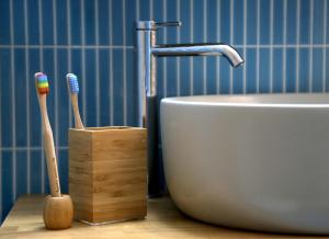 a bathroom with two toothbrushes and a sink at Down Town Sitia i in Sitia +15 photos