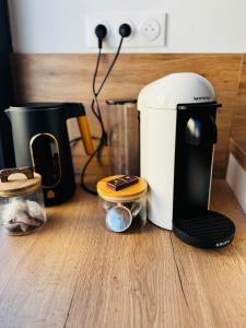 a coffee maker sitting on top of a counter at Wake up in white - Private Jacuzzi & cotton comfort in Verdun