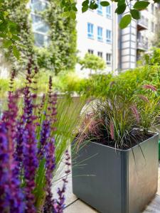 a large metal planter with plants in a garden at Boutique Hotel Atrium München in Munich