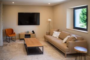 un salon avec un canapé et une table dans l'établissement Le Mas des Sources - 2 Piscines - by Zenlife, à Saint-André-dʼOlérargues