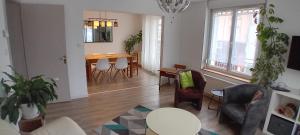 a living room with a table and chairs at Gérardmer Centre, Calme, 95m Spacieux in Gérardmer