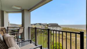 a balcony with chairs and a view of the ocean at 402 Summerhouse by AvantStay Beachfront Condo w Community Pool Access in Isle of Palms