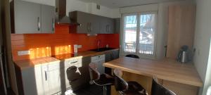 a kitchen with white cabinets and a wooden counter top at Gérardmer Centre, Calme, 95m Spacieux in Gérardmer +13 photos