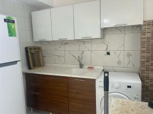 a kitchen with a sink and a washing machine at DİDİM Ege Apart in Didim +88 photos