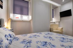 a bedroom with a blue and white bed and a window at Casa da Ladeira by Trip2Portugal in Figueira da Foz
