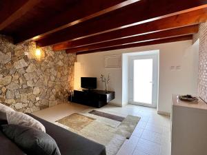 a living room with a stone wall and a door at Countryside Home by Trip2Portugal in Sobral da Abelheira