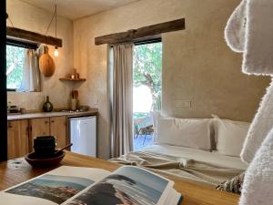 a bedroom with a bed and a table with a book at The Gate House Studio Sidi Kaouki in Essaouira