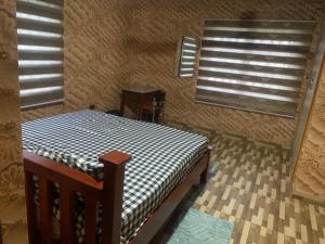 a small room with a bed and a window at Martino Guest House in Pokuase
