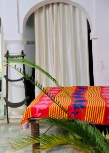 a colorful couch sitting in front of a window at Ganpati homestay in Pushkar +13 photos