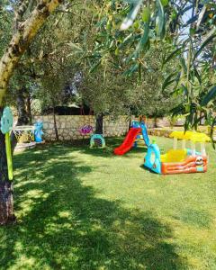 a group of childrens play equipment in a yard at Villa Elianna Lefkada in Tsoukaladhes
