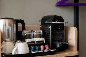 a coffee maker sitting on a tray next to a coffee pot at Premier Inn Berlin Alexanderplatz in Berlin