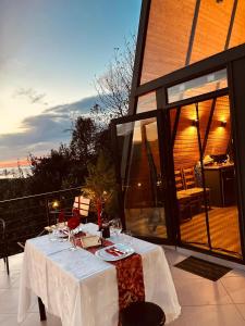 einen Tisch mit einem weißen Tischtuch auf einer Terrasse in der Unterkunft Orange Cottage in Agara