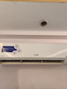 a white stove top oven in a white refrigerator at Frazyone Hostel in New Delhi