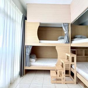 a room with two bunk beds and a window at Utopia Hostel in Taitung City