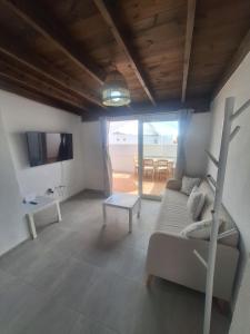 a living room with a couch and a table at Casa vista golf in Caleta De Fuste