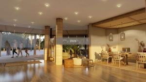 a lobby with a table and chairs in a building at Cala Millor Garden Hotel - Adults Only in Cala Millor