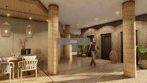a woman walking through a lobby with columns at Cala Millor Garden Hotel - Adults Only in Cala Millor