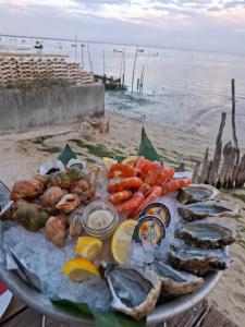 a plate of seafood and vegetables on the beach at Appartement de charme plein centre in Libourne