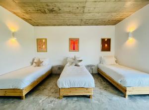 two beds in a room with white walls at Fazenda do Pomar by Trip2Portugal in Montemor-o-Novo +61 photos