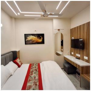 a hotel room with a bed and a sink at Hotel AV Ganges Varanasi - Walking Distance From BABA VISHWANATH TEMPLE #Wifi #Fully Air Conditioned & Spacious Rooms - Best Budget Hotel In Varanasi in Varanasi