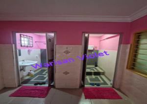 a bathroom with pink walls and mirrors and a sink at Homestay Warisan Violet Bertam Jaya in Melaka +10 photos