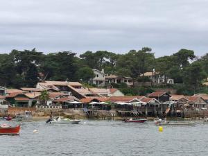 a group of boats on a body of water with houses at Appartement de charme plein centre in Libourne