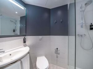 a bathroom with a shower and a toilet and a sink at Ibis Budget Barcelona Viladecans in Viladecáns